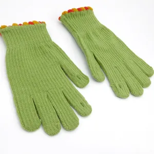 Winter warm knitted five-finger gloves with colorful ball cuffs, cozy solid green knit design.