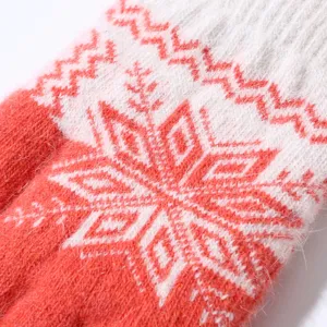 Close-up detail of winter warm knitted glove featuring cozy plush texture and nordic snow pattern.
