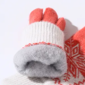 Detailed shot of thick winter knit gloves with soft fleece lining and warm jacquard design.