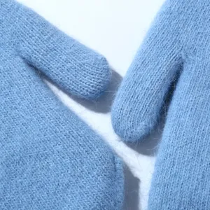 Soft light blue wool blend winter mittens close-up, thick cozy fuzzy thermal gloves for women.