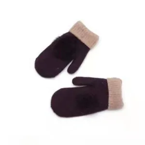 Detailed view of women winter warm fleece-lined knitted mittens with cute soft pom-pom and rib cuff.