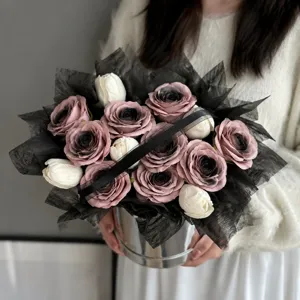 Detailed close-up of an elegant handmade rose bouquet gift box with black wrapping.