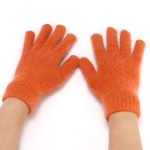 Detail view of orange fluffy knit gloves, warm rabbit hair winter five-finger gloves for women.
