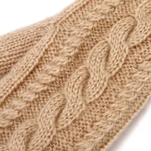 Close-up detail of women winter cable knit gloves, warm thick khaki woolen fabric pattern.