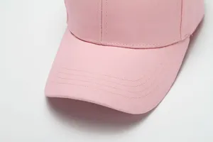 Close-up detail of a pink cotton baseball cap, plain sun hat for outdoor casual daily wear.