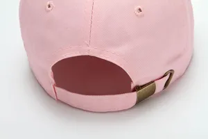 Close-up of pink cotton baseball cap back with adjustable strap and brass buckle.
