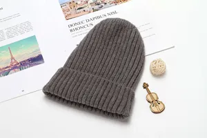 Grey knitted beanie hat winter warm ribbed cuff skull cap detail view soft cozy daily wear.