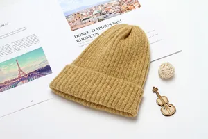 Detail view of the cozy ribbed winter knit beanie in camel, soft warm pull-on cap for cold days.