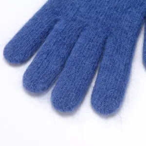 Close-up view of fluffy blue knitted rabbit hair blend five-finger winter warm gloves.