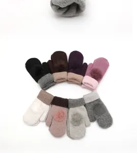 Winter knitted wool mittens with cute fur balls, thick warm plush gloves for women detail.