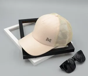 Close-up detail of the summer mesh baseball cap with metallic M letter and breathable fabric.