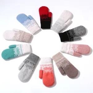 Close up of winter warm knit mittens featuring cozy plush material and classic snowflake pattern.