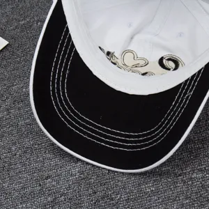 Detailed view of a fashionable black and white baseball cap with exquisite embroidery.