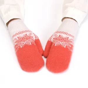 Cozy winter knit mittens with red and white nordic snowflake pattern, plush and warm design.