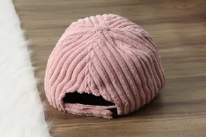 Pink corduroy baseball cap detail view, soft warm fabric with adjustable back strap design.