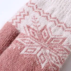 Close-up detail of soft fuzzy winter knit mittens with cozy snowflake pattern texture.