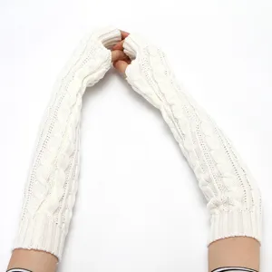 Detailed shot of white cable knit arm warmers, cozy long fingerless gloves winter style.
