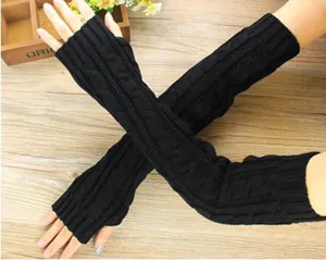 Detail view of black knitted fingerless arm warmers, cozy winter thermal gloves close up.