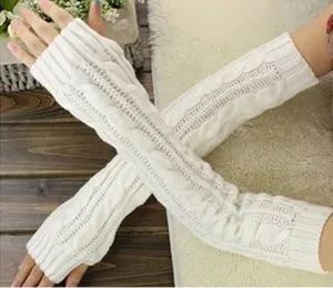 White knitted fingerless gloves detail view, showcasing the long arm warmer texture and craft.