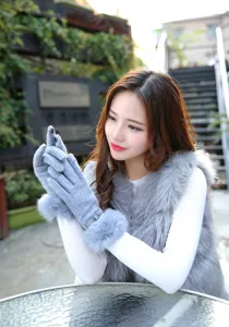 Grey winter touchscreen gloves detail, featuring cozy faux fur cuffs and cute bow decoration.