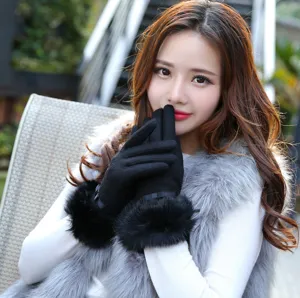 Close up detail of women autumn winter black touchscreen gloves with fluffy fur cuffs.