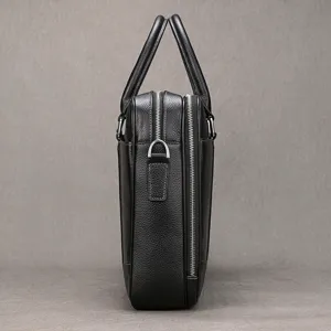 Leather briefcase side detail, premium cowhide business bag structure, durable metal zippers.