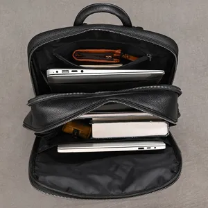 Top view of black leather business backpack detail, showing spacious compartments and storage.