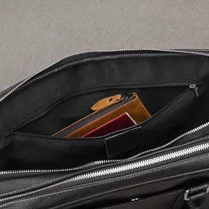 Leather briefcase interior detail showing spacious compartment and organizer pockets for business.