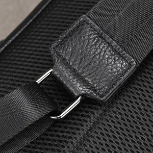 Detailed close-up view of durable men leather backpack strap, metal buckle and mesh backing.