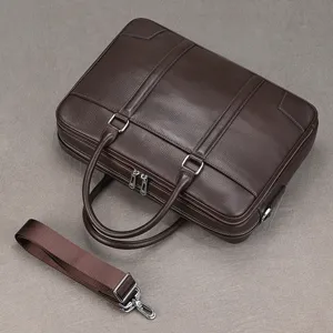 Close-up detail of a dark brown genuine leather business briefcase with shoulder strap.