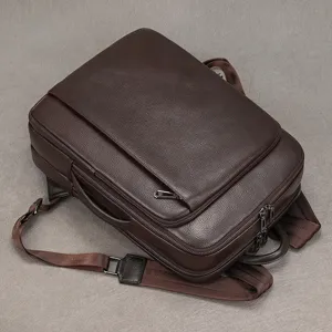 Premium brown leather business backpack for men, durable laptop daypack with multiple zipper compartments.