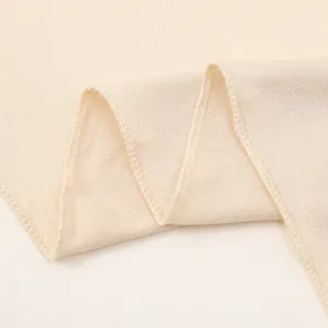 Close-up detail view of soft mercerized cotton hijab fabric featuring neat overlock stitching.