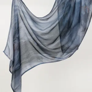 Detailed view of the soft rayon printed long scarf, lightweight shawl fabric texture close up.