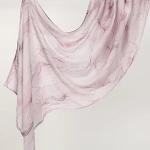Detailed shot of a lightweight pink rayon long scarf featuring elegant abstract marble print draping.