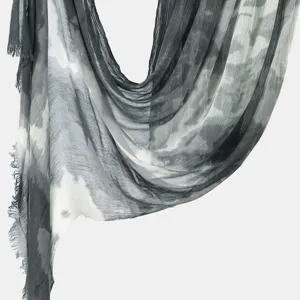 Detailed close-up of the grey and white tie-dye textured fabric drape with soft fringe.