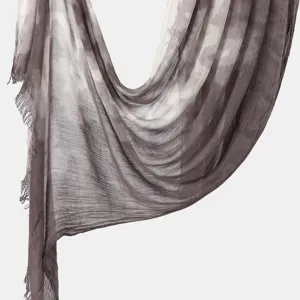 Close-up detail of the lightweight tie-dye crinkle scarf showcasing texture and elegant drape.