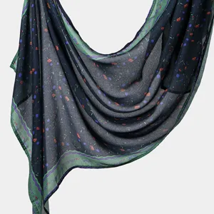 Close-up view of the printed long scarf showing soft draped fabric and vibrant colorful details.