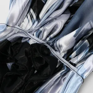 Satin turban cap detail view, featuring smooth blue abstract print and gathered elastic pleats.