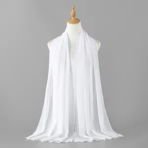 Close up view of white chiffon long scarf detail, lightweight fabric with lace trim.