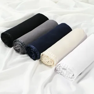 Detailed view of rolled chiffon hijabs with delicate heart lace trim in various solid colors.