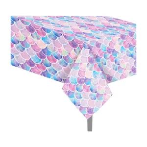 Detailed view of the colorful mermaid scale pattern table cloth, vibrant pink and blue print.