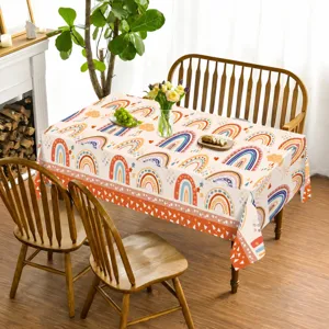 Bohemian rainbow tablecloth detail showing colorful pattern on wooden dining table setting.