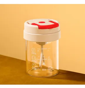 Close up view of the portable electric glass shaker cup with clear scale marks and stirring rod.