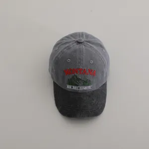 Detailed view of the washed grey baseball cap featuring Montana embroidery and mountain design.