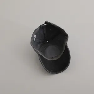 Detailed view of the dark grey washed baseball cap interior showing lining and label.