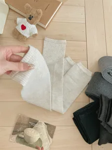 Knit leg warmers detail showing soft ribbed texture and stretchy fabric for winter warmth.