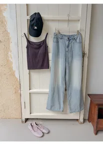 Casual women clothing set featuring thermal camisole, wide-leg jeans and stylish cap.