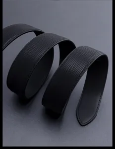 Close-up detail of a textured black leather belt, ideal for business and casual wear.