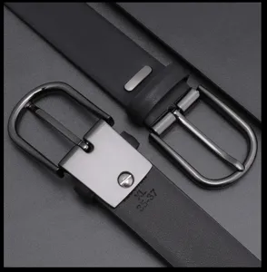 Close-up detail of mens black leather belt with metal pin buckle, smooth finish strap.