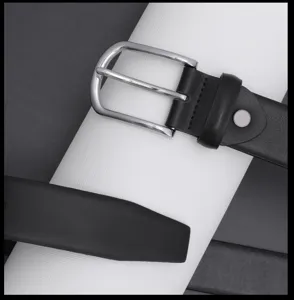 Men's black leather belt detail close-up, classic silver metal pin buckle and textured strap.